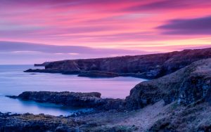 Sea cliffs in Stonehaven, pink sunset